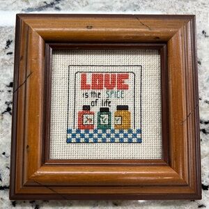 Framed Cross-Stitch Art with Love Quote stating “Love is the Spice of Life”